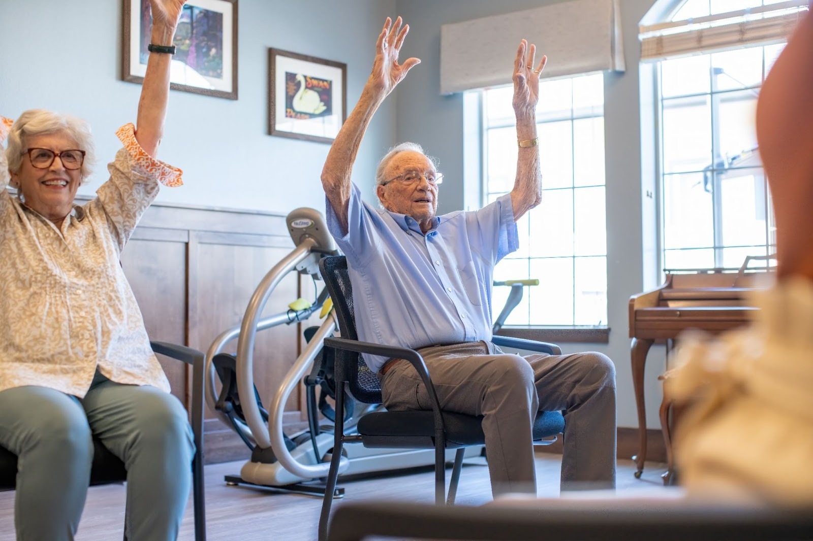 Senior residents at High Plains Crossing participate in a gentle seated mobility exercise.